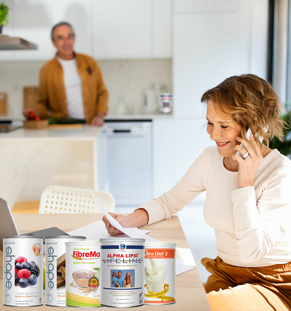 Happy senior woman talking on smartphone and checking bills when husband preparing dinner at kitchen, selective focus Happy senior woman talking on smartphone and checking bills when husband preparing dinner at kitchen, selective focus on smiling wife. Solving vacation issues. Utility bills documents